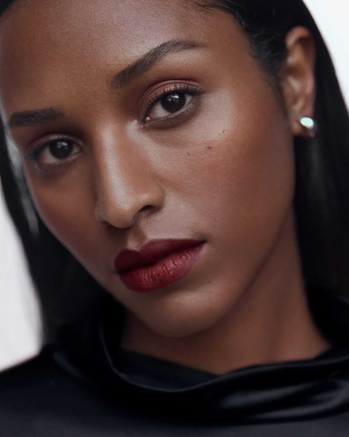 Manasi 7 campaign image for the shade Pacaya with berry lips on dark skin.